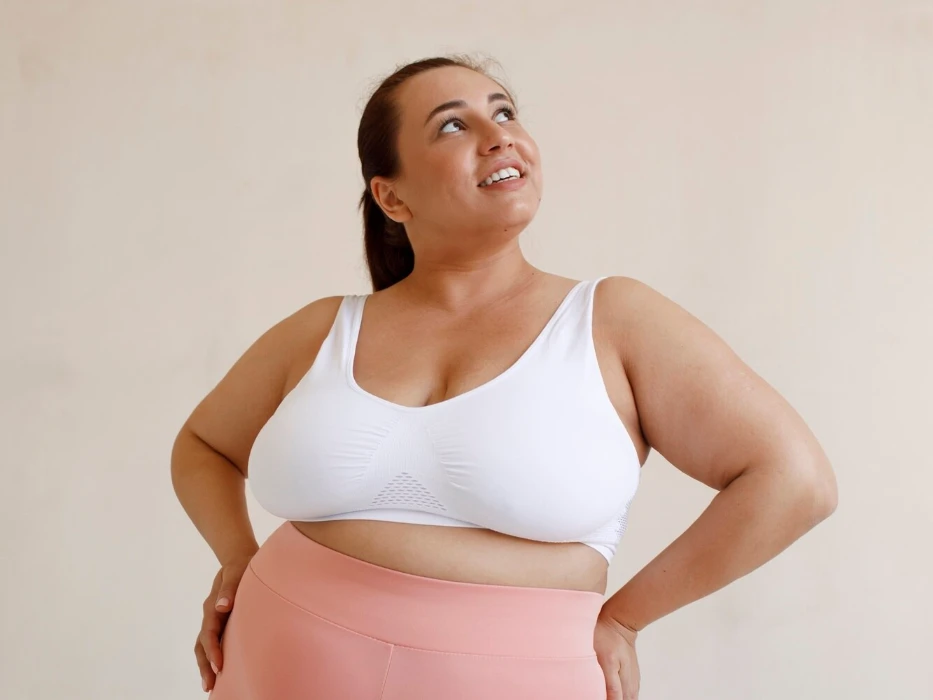 Front view plus size woman posing in studio